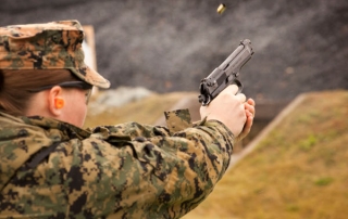 Female Marine Firing A Pistol